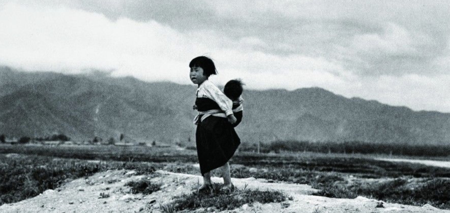 Children walking across a ruined field, refugees of the Korean War