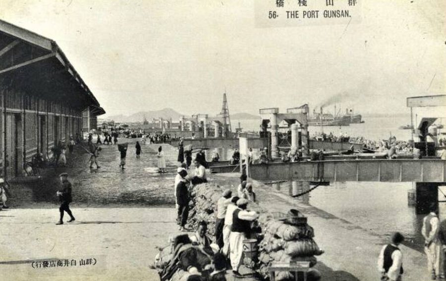 Workers carrying sacks of rice at the docks